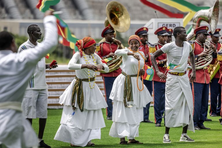 Performers wave Ethiopian flags and dance traditional songs during the official inauguration ceremony of the Grand Ethiopian Renaissance Dam (GERD) in Guba, on September 9, 2025.
