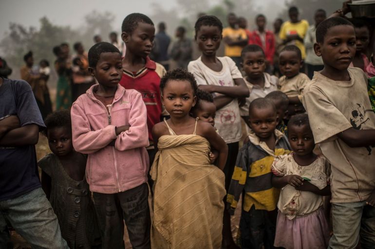 Congolese children attend the Brilliant Mobile School, while other children who can not afford to attend the school stand by and watch, in the village of Lungudi, in the south west region of the Democratic Republic of Congo in Kasai, the heart of the diamond mining area in the DRC, August 7, 2015. Diamond buyers and manufacturers in the west are trying to find a way to make the diamond industry cleaner and more responsibly-sourced, in order to combat human rights abuses, child labor, the degradation of the environment, and unfair trade practices. (Photo by Lynsey Addario/Getty Images Reportage)
