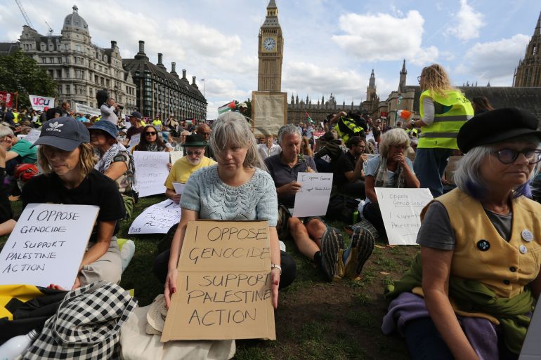 LONDON, ENGLAND - SEPTEMBER 6: Protesters hold up signs saying 'I oppose Genocide - I support Palestine Action' during the demonstration in Parliament Square on September 6, 2025 in London, England. The UK Government will be able to challenge the decision to allow activist group Palestine Action's appeal against their proscription as a terrorist organisation. (Photo by Martin Pope/Getty Images)